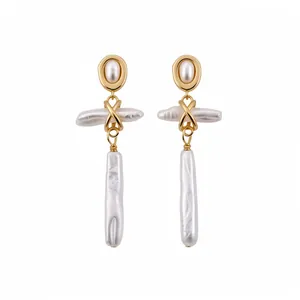 Elegant gold-tone oval pendant earrings featuring baroque freshwater pearls in a retro style.