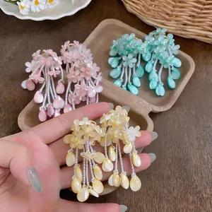Vibrant dopamine-style colorful flower tassel earrings in pink, cyan, and yellow