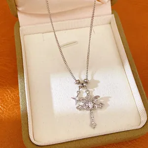 Macro view of silver gothic double cross necklace with shimmering zircon star pendant