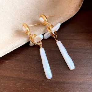 Detailed view of the natural texture of baroque freshwater pearls on gold drop earrings