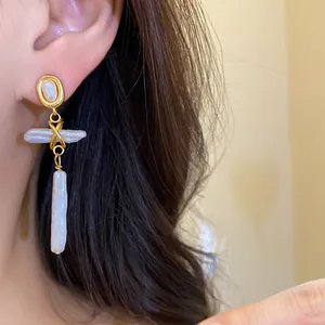 Detail shot of vintage freshwater pearl drop earrings with gold-toned metal accents