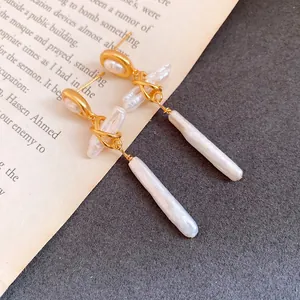 Close-up detail of baroque freshwater pearl drop earrings with gold twisted wire