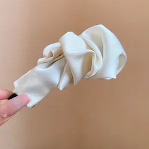 Elegant cream white satin banana hair clip designed for high ponytail styling detail