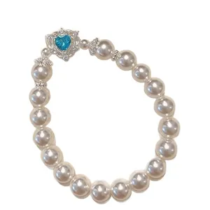 Elegant French vintage pearl bracelet featuring a blue heart-shaped gemstone center