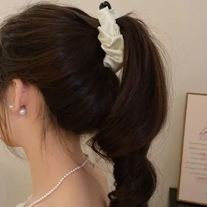 Elegant cream ruffled fabric banana clip for high ponytail styling on brunette hair