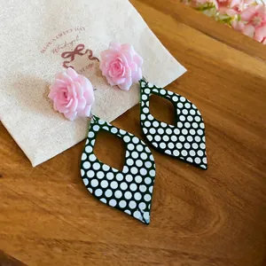 Retro green and white polka dot dangle earrings with elegant pink rose design