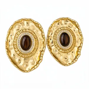 Vintage hammered gold oval earrings featuring dark resin center and crystal halo accents