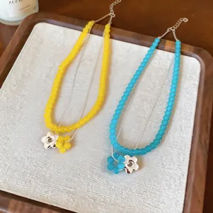 Detail of French style glass bead double-layer necklaces with yellow and blue flowers