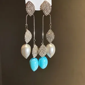 Vintage luxury earrings with rhinestone leaves and blue teardrop pendants on silver needles