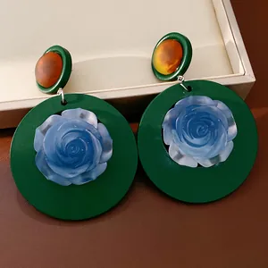 Detailed close-up of vintage resin flower drop earrings featuring blue rose design