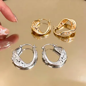 Elegant zircon twisted hollow geometric hoop earrings in gold and silver finish.