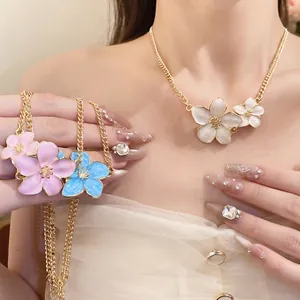 Elegant enameled flower necklace in pink blue and white on a delicate gold chain