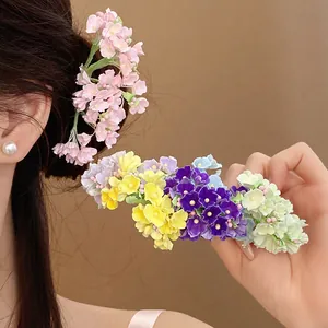 Detailed macro view of a colorful floral hair pin with delicate multi-colored petals