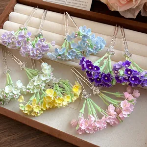 Detailed macro view of colorful handmade flower hairpins in a velvet jewelry box