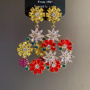 Close-up of French vintage colorful zirconia floral dangle earrings with gold finish