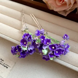 Detailed close-up of handmade purple floral hairpins featuring delicate fabric petal textures