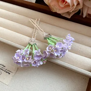 Close-up detail of delicate lilac purple flower clusters on traditional Chinese style hairpins