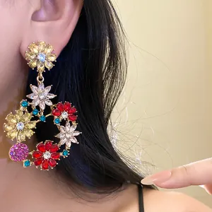 Detail view of colorful zircon flower drop earrings with a vintage French aesthetic