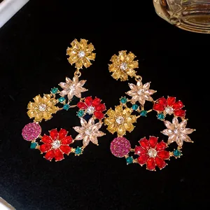 Macro view of colorful floral drop earrings with sparkling multi-colored zircons.
