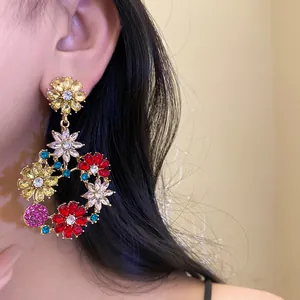 Detailed view of colorful crystal flower drop earrings in French vintage style