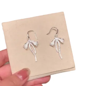 Elegant silver-colored bow tassel drop earrings with sparkling cubic zirconia for women