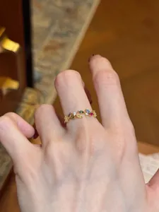 Detailed view of a vintage leaf-shaped gold open ring with colorful zircon stones