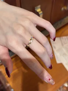 Detailed view of a vintage gold-toned open ring featuring colorful zircon leaf patterns