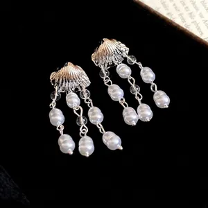 Elegant silver shell stud earrings featuring triple strand white pearl tassel drops