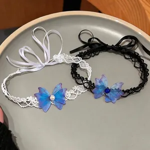 Elegant lace choker set with blue chiffon butterflies and pearl details on plate