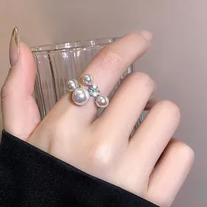 Elegant French retro open ring with sparkling zircon and clustered pearls.