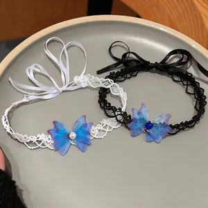 Close-up of black and white lace chokers with blue chiffon butterflies and pearls.