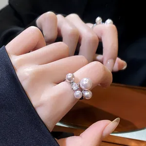 Elegant French vintage style pearl and zircon open ring displayed as a detail shot