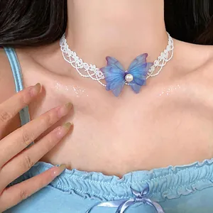 Detail view of a dainty white lace choker featuring a blue chiffon butterfly and pearl