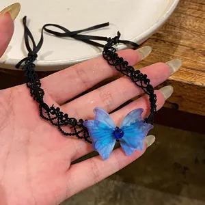 Detailed view of a blue chiffon butterfly choker with black lace and blue gemstone