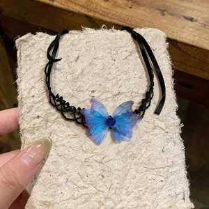 Macro view of a delicate blue chiffon butterfly choker with black lace and ribbon