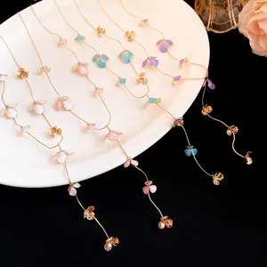 Detailed macro view of delicate enamel petal tassel necklaces in vibrant pastel colors.