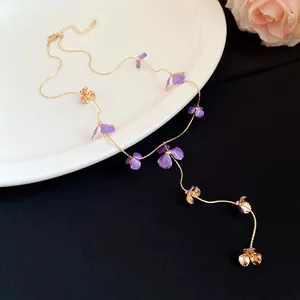 Elegant purple enamel flower tassel necklace with delicate gold-plated chain details.
