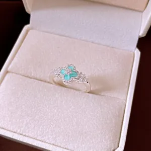 Elegant minimalist silver ring featuring turquoise flower and pavé stones in jewelry box
