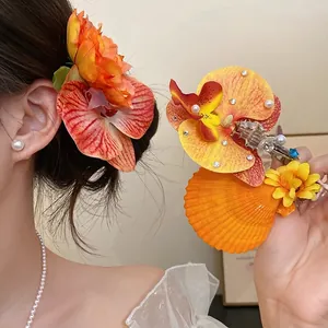 Elegant floral hair clip with pearls and seashells for beach vacation, duckbill style.
