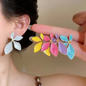 Detailed view of colorful leaf-shaped oil-drop earrings in multiple vibrant hues