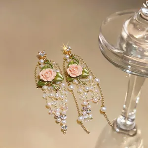 Elegant French style pink rose earrings with pearl tassels and shimmering cubic zirconia.