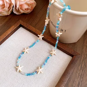 Detail showing blue crystal beads and white starfish charms of the Bohemian necklace