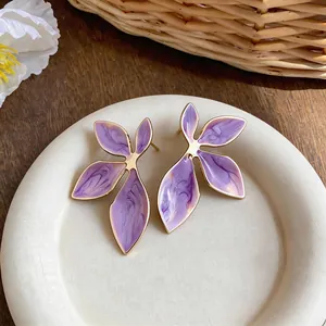 Elegant purple enamel leaf stud earrings with gold trim and marble texture finish.