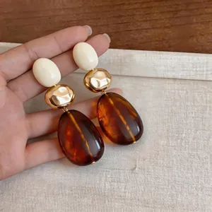 Retro Maillard style geometric resin earrings with amber drops and gold accents