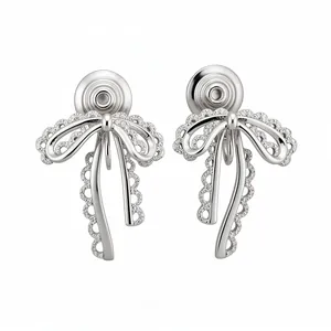 Elegant silver-tone bow knot clip-on earrings with lace edges and sparkling pavé stones