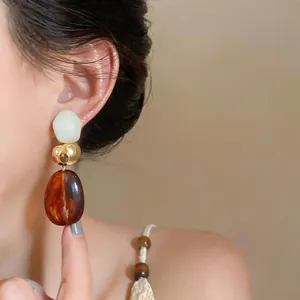 Detailed close-up showing vintage Maillard style geometric resin drop earrings on an ear