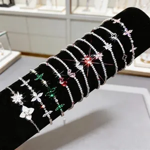 Elegant silver flower bracelets with colorful zircon stones on black velvet display
