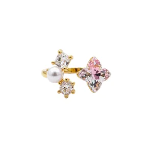 Elegant open pearl ring with pink flower-shaped gemstone and clear cubic zirconia