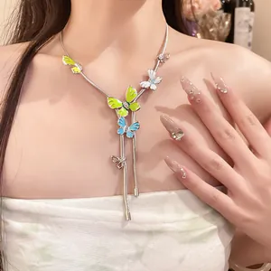 Close-up view of a model wearing an enamel butterfly pendant necklace with rhinestones