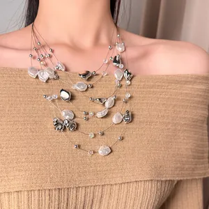 Close-up of a vintage multi-strand necklace with irregular pearls and silver beads